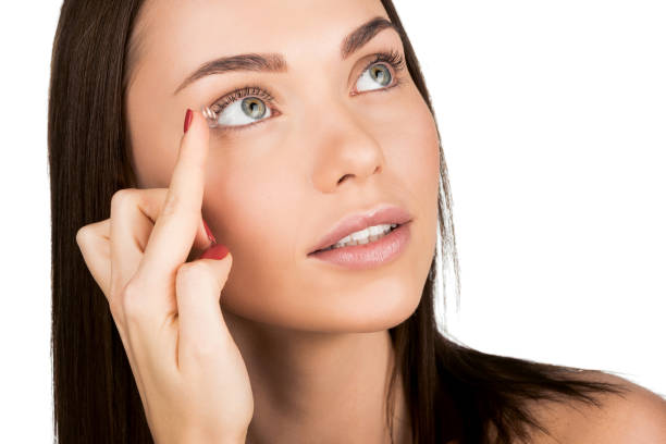 istock woman applying contact lens 876133218