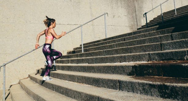 istock Fitness woman running up on steps 876134006