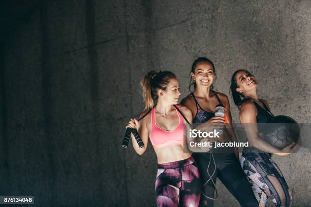 Group Of Female Friends Relaxing After Workout Stock Photo - Download Image Now - Exercising, Healthy Lifestyle, Friendship