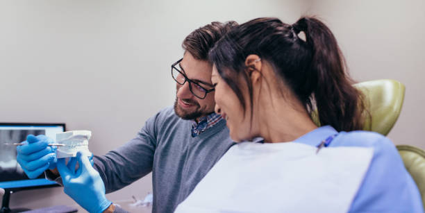 istock Dentist demonstrating dental care to patient 876140202
