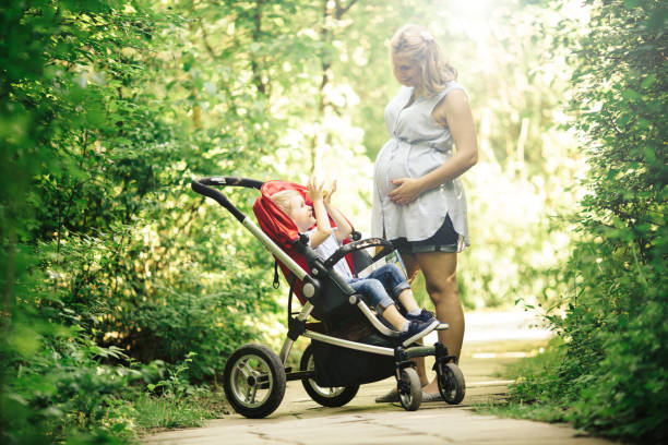 istock Woman walking with child in forest 876143632