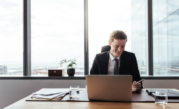 istock Businessman working at his desk and smiling 876146804