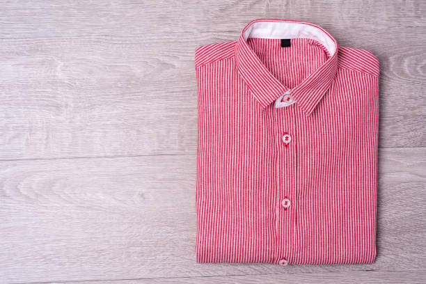 istock New man shirt red on wood background. 876146886