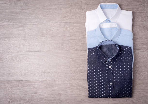 istock New man's shirt white on wood background. 876146902
