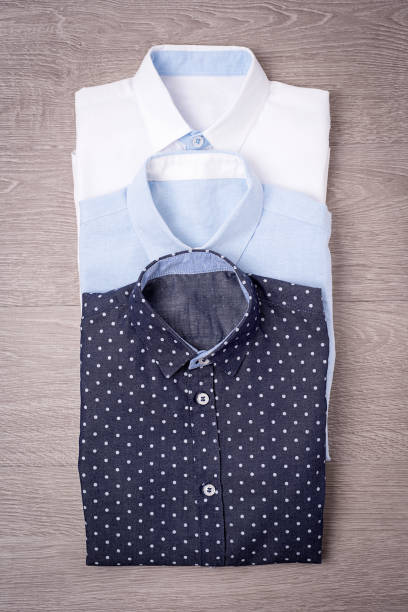 istock New man's shirt white on wood background. 876146930
