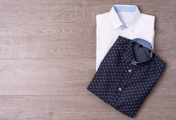 istock New man's shirt white on wood background. 876146934