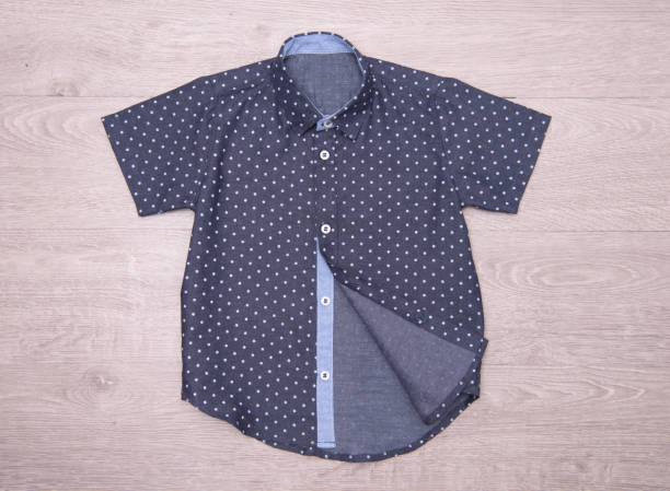 istock Dark blue polka dot shirt for boys on wood background 876147020