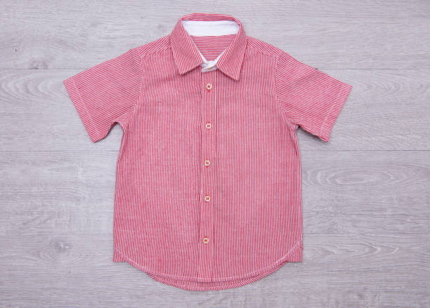 istock blue shirt for boys on wood background 876147094