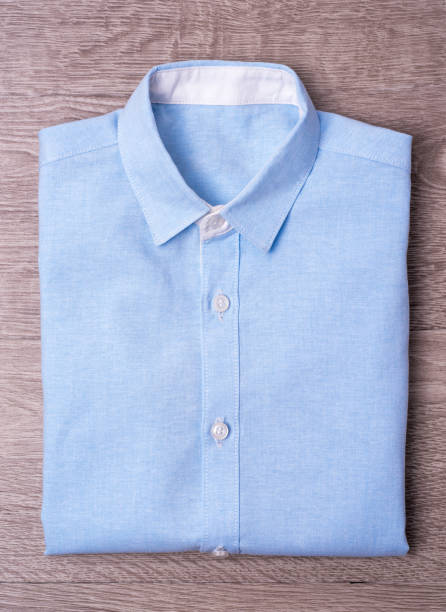 istock New man shirt blue on wood background 876147096