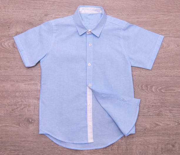 istock blue shirt for boys on wood background 876147098