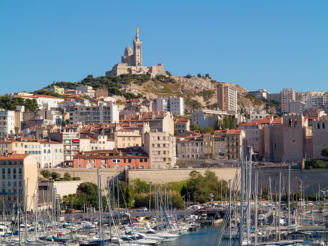 General view of the Marseille's Vieux Port with the Notre Dame de la Garde Cathedral on the top of the mountain