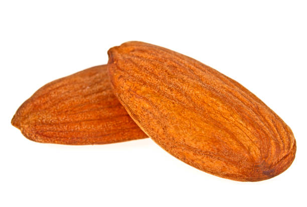 istock Closeup of two almond nuts isolated on a white background 876154084