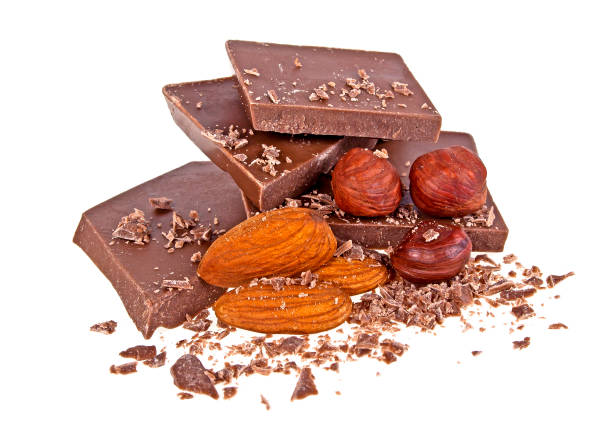 istock Heap of broken chocolate with nuts isolated on a white background 876158866