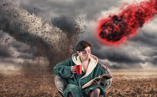 areless man drinking coffee and reading a book while a tornado and a meteor coming to him.
