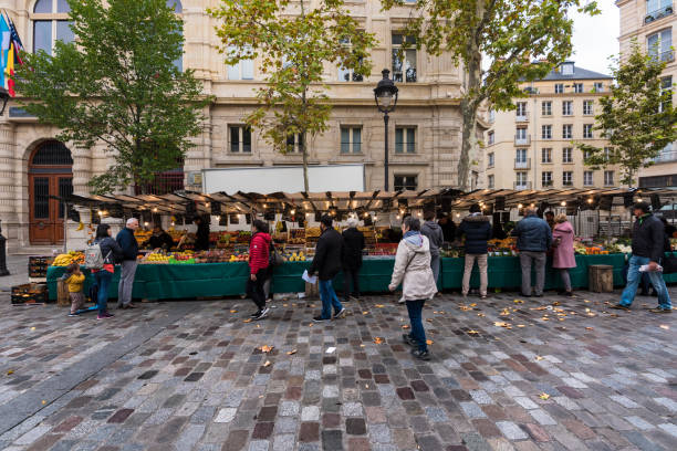 Paris, France -- November 4, 2017 -- Shoppers at a Parisan farmers market in Autumn. Editorial Use Only.