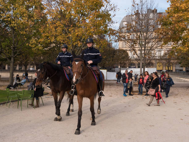 Paris, France -- November 3, 2017 -- Mounted French police officers patrol the Tuilery Gardens. Editorial Use Only.