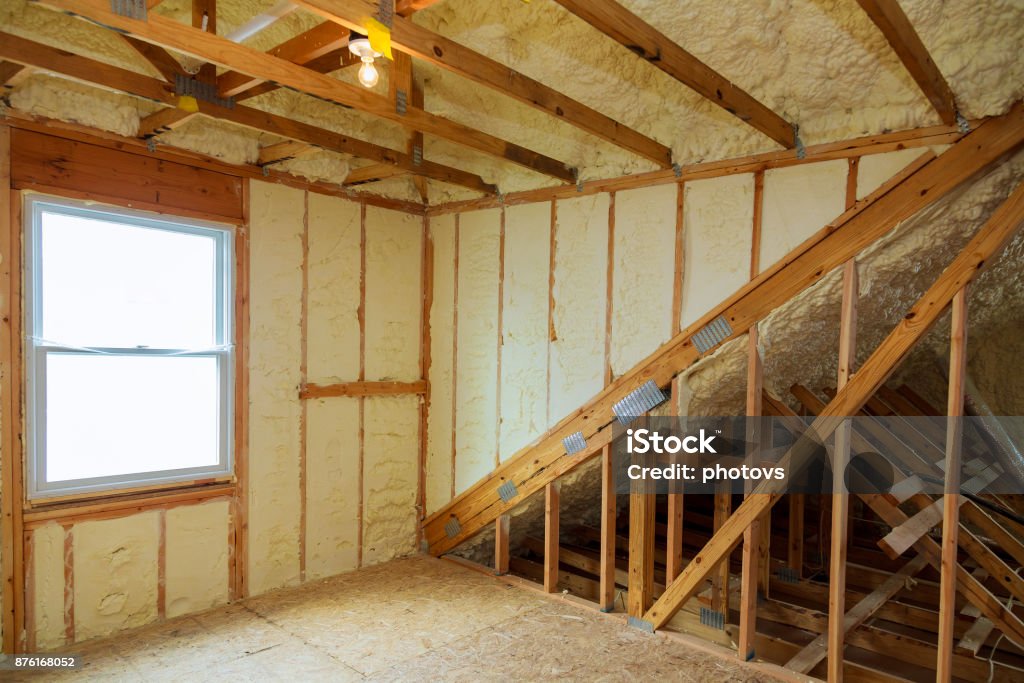 A room at newly constructed home is sprayed with liquid insulating foam A room at a newly constructed home is sprayed with liquid insulating foam Insulation Stock Photo