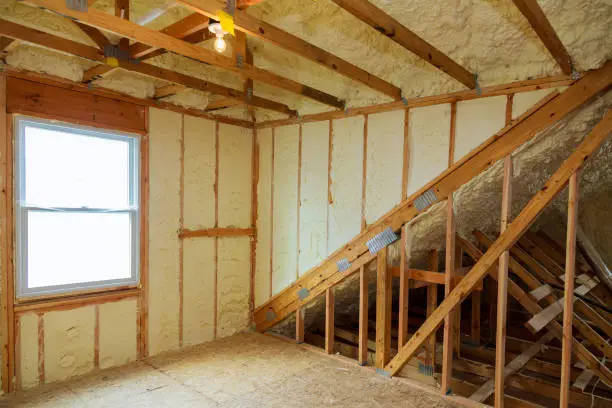 Photo of A room at newly constructed home is sprayed with liquid insulating foam