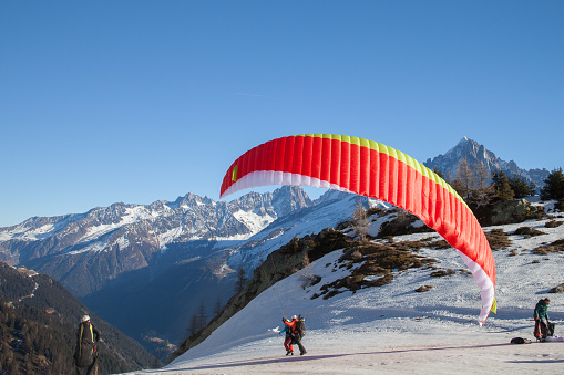 Chamonix: A paraglider tandem takes off in sunny winter day