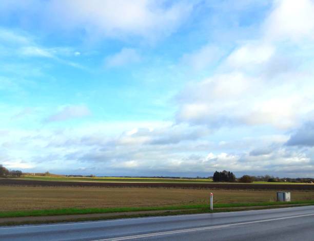 istock Farm landscape from road point 876175048