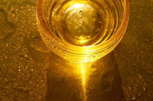 istock Golden texture with water drops.Thirst and its quenching 876177170