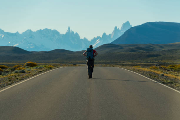 Adventure on the open road Backpacker walking along route 23 to El Chalten Argentina chalten photos stock pictures, royalty-free photos & images