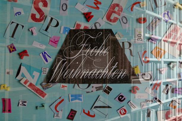 istock Frohe Weihnachten (German text) on letters and books background 876177952