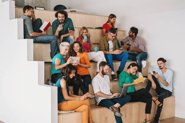istock Large group of people texting, surfing and reading 876181356