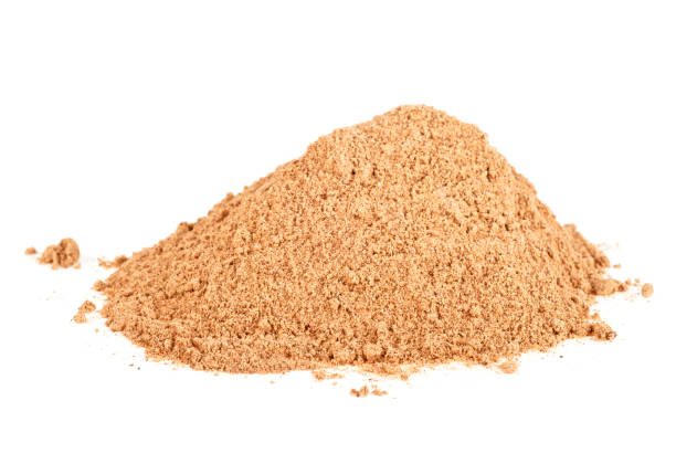 istock Pile of cinnamon powder isolated over white background 876181720