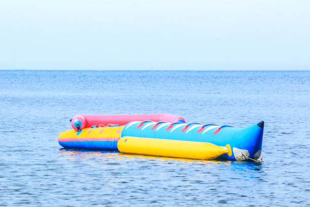 istock Banana boat floating in the blue sea 876187514