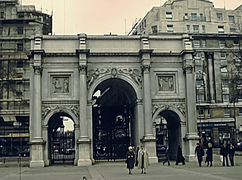 LONDON, UNITED KINGDOM - CIRCA 1979: Tourists walking in the square of the Marble Arch doorway. Historic restored image on 1970s.