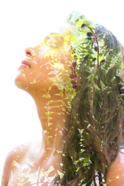 istock Double exposure of a young natural beauty relaxing and softly tilting her head back as her forehead and hair combines perfectly with tree branches and leaves 