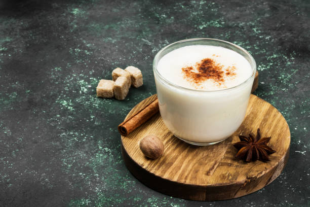 istock Christmas drink eggnog and ingredients on a green background. Copy space 876202870