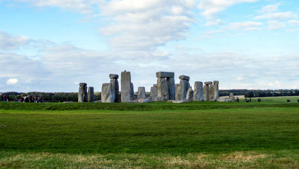 istock Stonehenge prehistoric monument,  green grass, blue sky and clouds, panoramic view - Wiltshire, Salisbury, England, UK 876242062