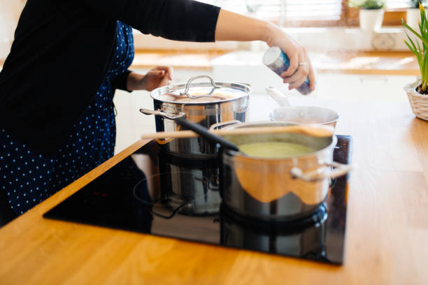 istock Woman adding spices to food 876242354