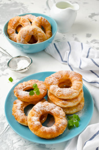 istock Homemade fried vanilla cottage cheese donuts on a white concrete background 876272820
