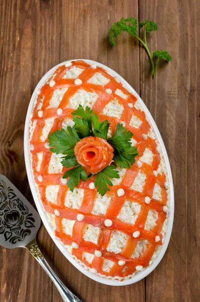 istock Festive salad, decorated with salmon on a wooden table 876272886