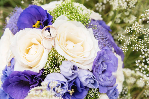 istock wedding gold rings lie on a wedding bouquet 876275374