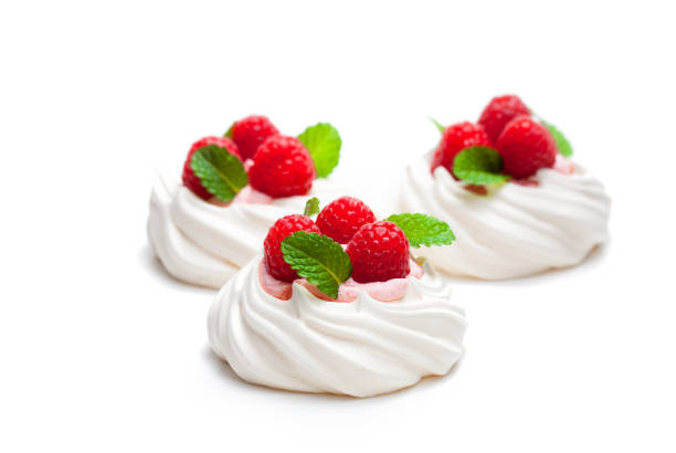 istock Mini  Pavlova meringue nests with berries and mint on isolated on white 876275592