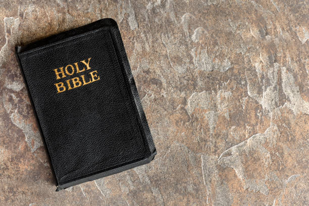 istock Old Bible Closed Top View over Stone Background 876275918
