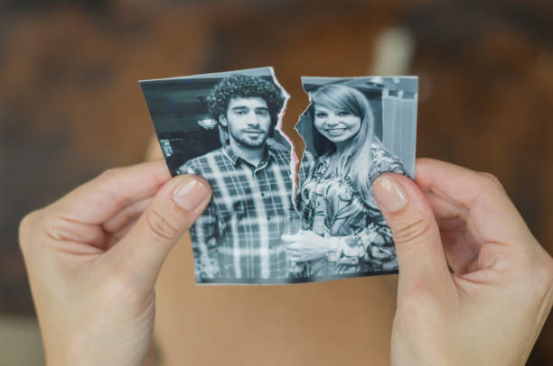 Great concept of divorce. Great concept of divorce, betrayal, separation, woman hand ripping photo of the couple. torn photos stock pictures, royalty-free photos & images