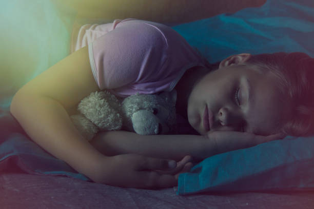 istock Little blond child sleeping in his bed with toy. 876276634