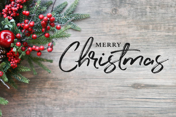 istock Merry Christmas Text with Christmas Evergreen Branches and Berries Over Rustic Wooden Background 876289252