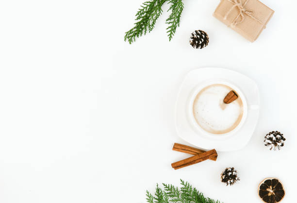 istock Christmas. Cup of coffee, larch branches, cinnamon sticks, over white background. Flat lay composition 876289540