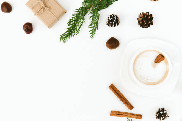 istock Christmas. Cup of coffee, larch branches, cinnamon sticks, over white background. Flat lay composition 876289612