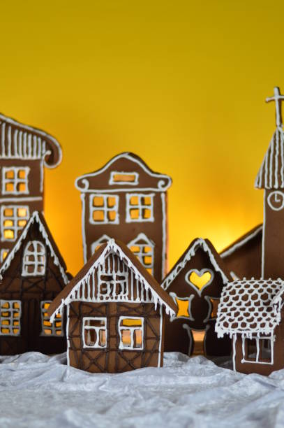 istock home made gingerbread village with yellow background 876292624