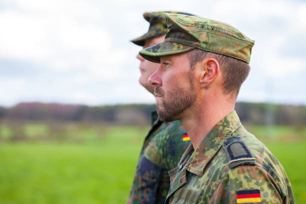 two german soldiers looks to the side