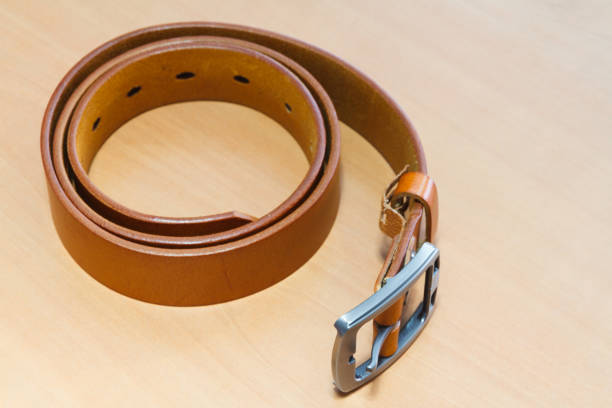 istock Roll up belts on a wooden background. 876314986