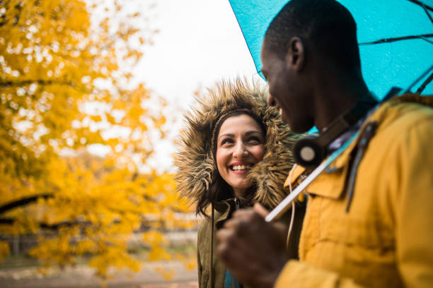 istock Happy couple in rain 876318388