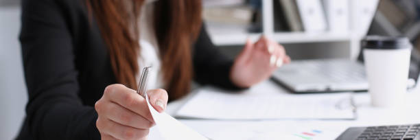 istock Female hand holding silver pen ready to make 876321990